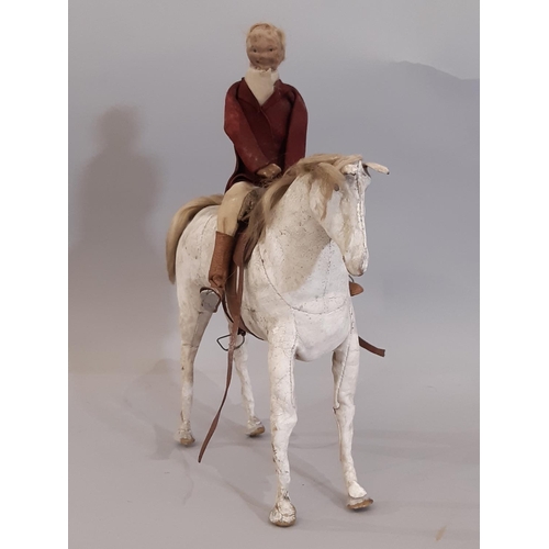 833 - Two 19th century  horse and rider leather toys comprising a white horse height 20cm with rider dress... 