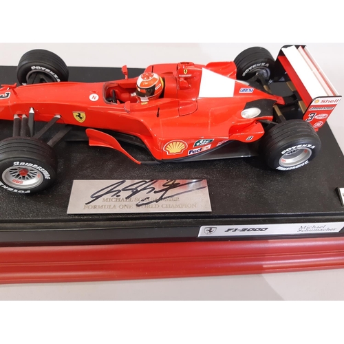 831 - Formula 1 interest: Michael Schumacher signed  2000 model car 1:18 scale  on plinth with purchase re... 