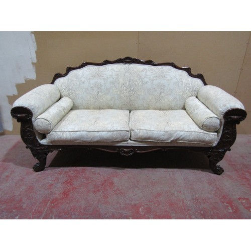 A Regency drawing room sofa with showwood frame depicting shells, scrolls and other detail, raised on lion's paw feet, with raised and shaped back, recently re-upholstered finish, 2m wide