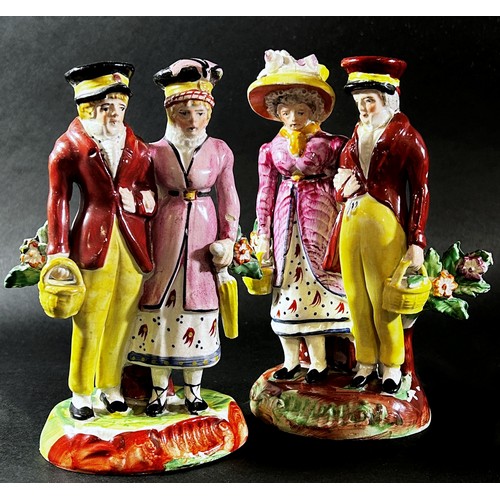 68 - Two Staffordshire pearlware figure groups, each depicting a dandy and dandizette in Regency dress, w... 