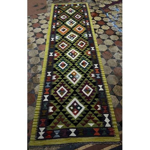 1496 - A Maimana Kilim Runner with a lime green border around a field of stepped diamond medallions 292cm x... 