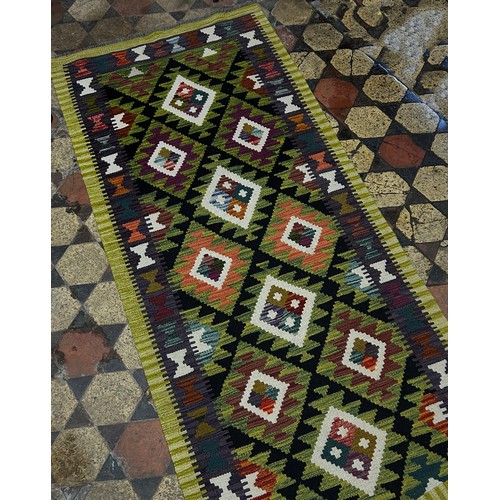 1496 - A Maimana Kilim Runner with a lime green border around a field of stepped diamond medallions 292cm x... 