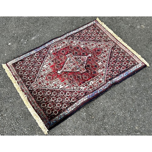 1494 - A small Persian prayer mat with an all over floral pattern, 130cm x 80cm, an old Bokhara carpet with... 