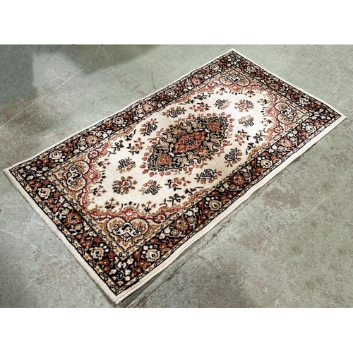 1499 - A modern machine made Persian style carpet in pink and brown tone on a cream ground, 180cm x 90cm ap... 