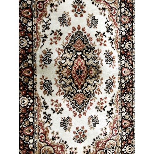 1499 - A modern machine made Persian style carpet in pink and brown tone on a cream ground, 180cm x 90cm ap... 