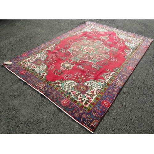 1504 - A vintage Persian Tabriz carpet with a multi coloured ground, 276cm x 189cm