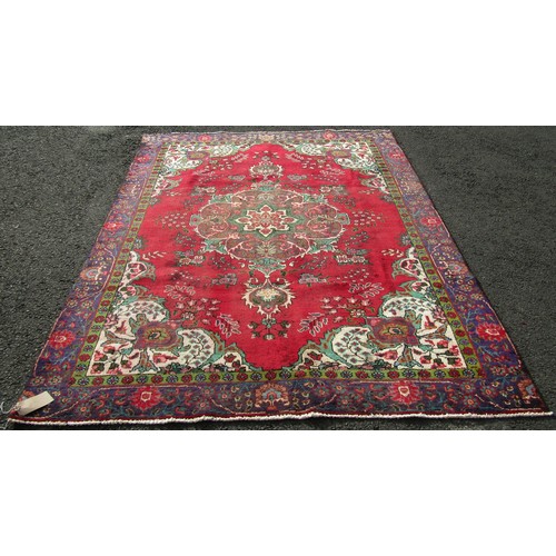 1504 - A vintage Persian Tabriz carpet with a multi coloured ground, 276cm x 189cm