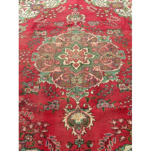 1504 - A vintage Persian Tabriz carpet with a multi coloured ground, 276cm x 189cm