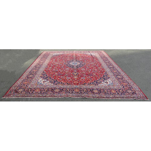 1514 - A Persian Kashan carpet with rich red ground and traditional floral medallion, 393cm x 300cm