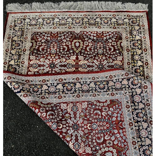 1498 - A silk Bidjar design carpet with an all over floral pattern and floral borders, 190cm x 120cm