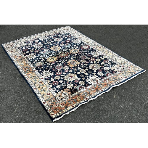 1501 - A Serapi type carpet with a large floral design on a blue ground, 220cm x 160cm.