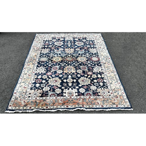 1501 - A Serapi type carpet with a large floral design on a blue ground, 220cm x 160cm.