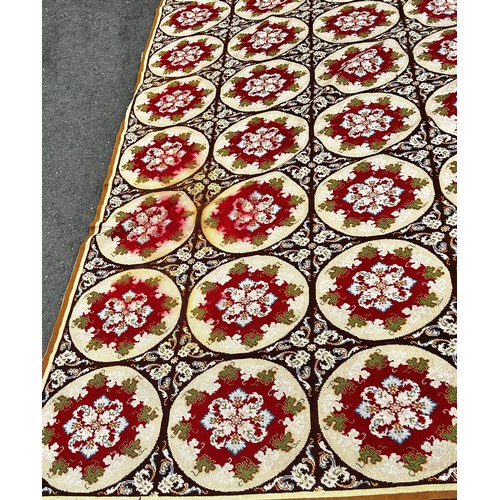 1507 - A 19th century needle point carpet/wall hanging, with eighty circular panels with floral posies to t... 