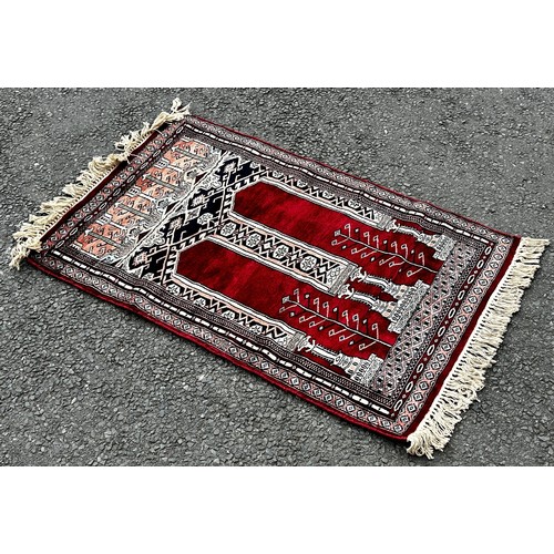 1510 - A small silk prayer mat, a small Bokhara rug with a single row of guls, a small Bokhara with two row... 