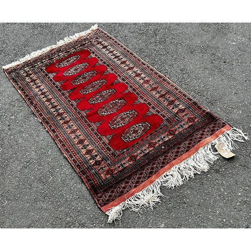 1510 - A small silk prayer mat, a small Bokhara rug with a single row of guls, a small Bokhara with two row... 