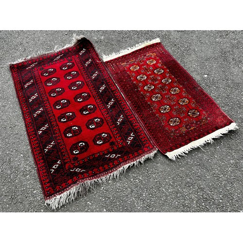 1510 - A small silk prayer mat, a small Bokhara rug with a single row of guls, a small Bokhara with two row... 