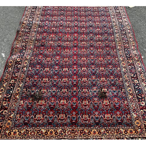 1513 - An old Doroskh rug with a tight Paisley design in blue and red tones, 222cm x 140cm