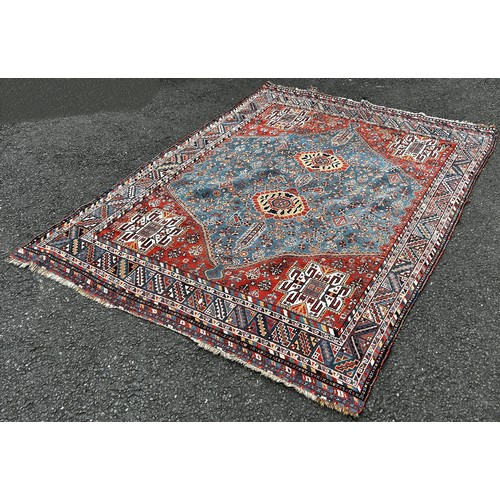 1503 - A Heriz Persian carpet with a central medallion with two interlocking lozenge with a red surround 21... 