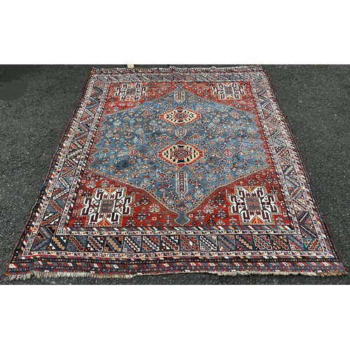 1503 - A Heriz Persian carpet with a central medallion with two interlocking lozenge with a red surround 21... 