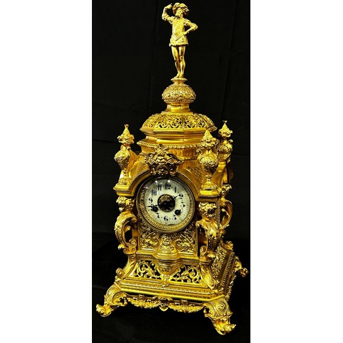 446 - A 19th century gilt brass mantle clock, the casework with pierced and scrolled detail, surmounted wi... 