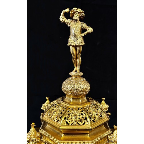 446 - A 19th century gilt brass mantle clock, the casework with pierced and scrolled detail, surmounted wi... 