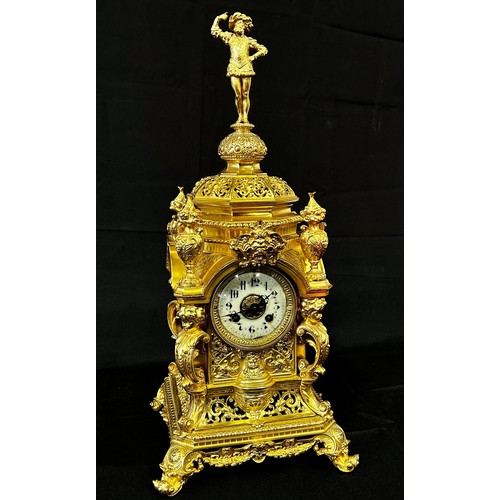 446 - A 19th century gilt brass mantle clock, the casework with pierced and scrolled detail, surmounted wi... 