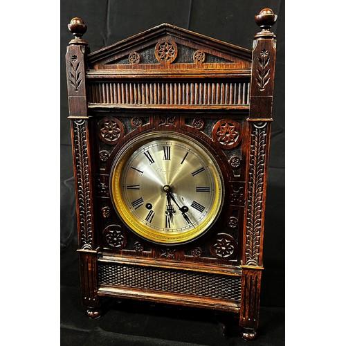 445A - Elkington & Company, an oak cased bracket clock in the Aesthetic Movement manner, the silvered dial ... 