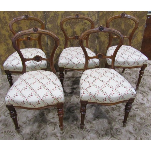 1074 - A set of five Victorian walnut balloon back dining chairs with carved and moulded frames