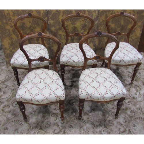 1074 - A set of five Victorian walnut balloon back dining chairs with carved and moulded frames