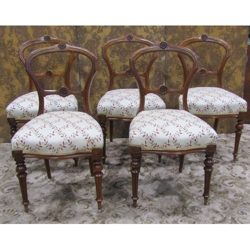 1074 - A set of five Victorian walnut balloon back dining chairs with carved and moulded frames