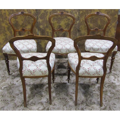 1074 - A set of five Victorian walnut balloon back dining chairs with carved and moulded frames