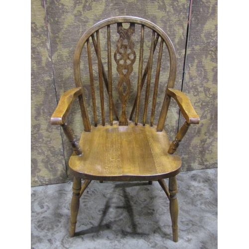 1075 - A set of four (3&1) Windsor stained beechwood wheelback dining chairs together with two rush seated ... 