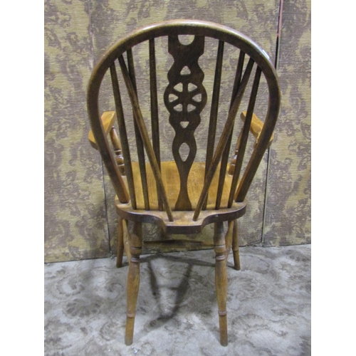 1075 - A set of four (3&1) Windsor stained beechwood wheelback dining chairs together with two rush seated ... 