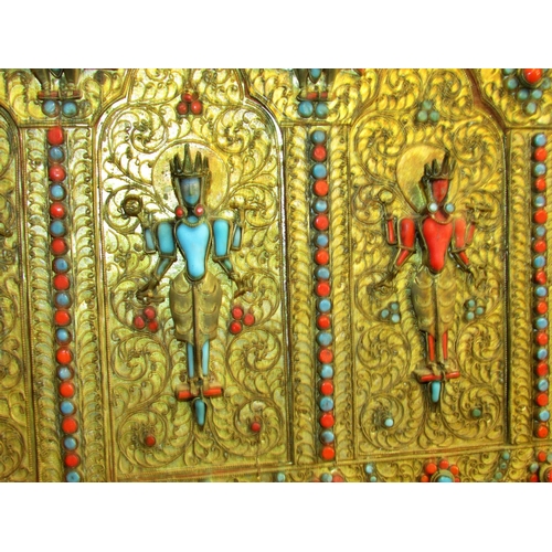 1727 - A Nepalese gilt-metal Buddhist panel, c.19th century decorated with standing Buddhist motifs, intric... 