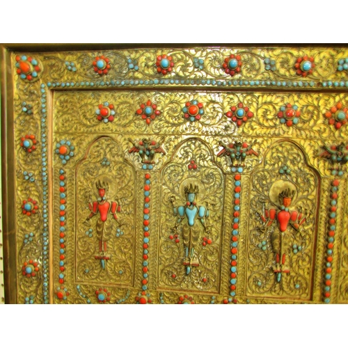 1727 - A Nepalese gilt-metal Buddhist panel, c.19th century decorated with standing Buddhist motifs, intric... 