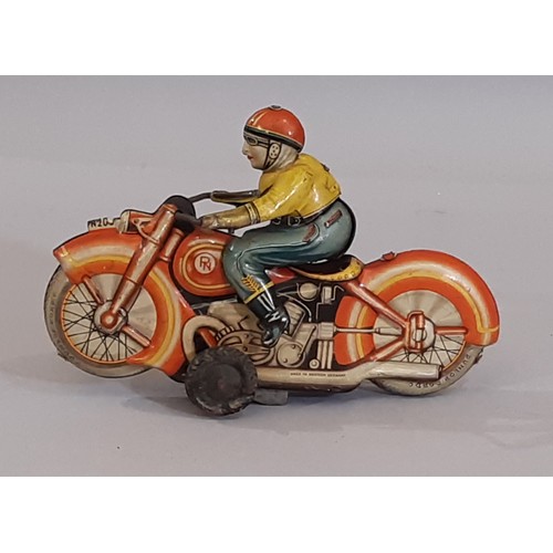 818 - A vintage clockwork  tin plate motorcycle and rider, made in West Germany. Length 16cm