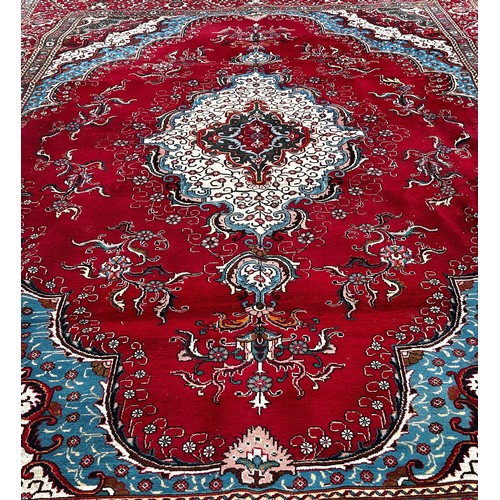 1528A - A very large Country House Persian Carpet, with an extended central floral medallion and trailing fl... 