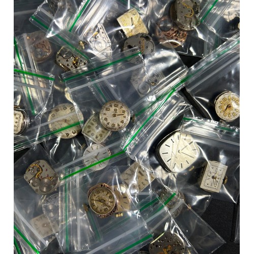 440B - A large collection of Swiss and other assorted wristwatch elements to include dials, springs, calend... 