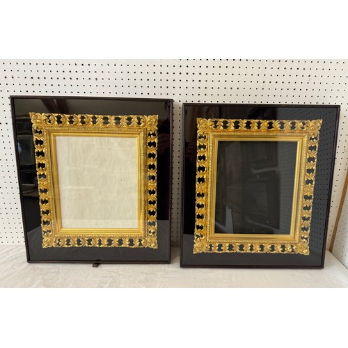 1655 - A pair of ornate pierced gilt frames with scrolling leaf decorations, housed in shadow box frames, B... 