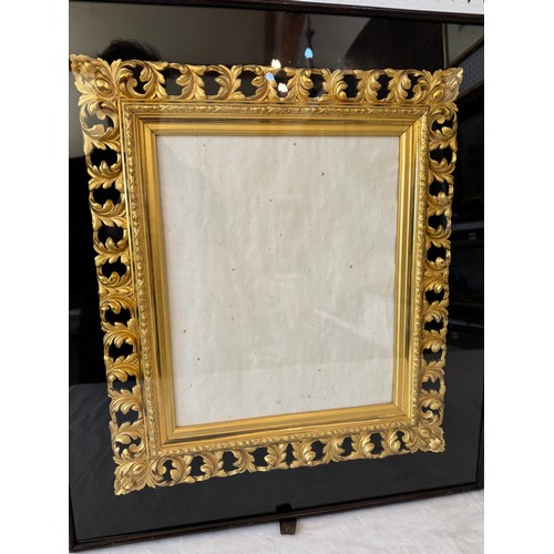 1655 - A pair of ornate pierced gilt frames with scrolling leaf decorations, housed in shadow box frames, B... 