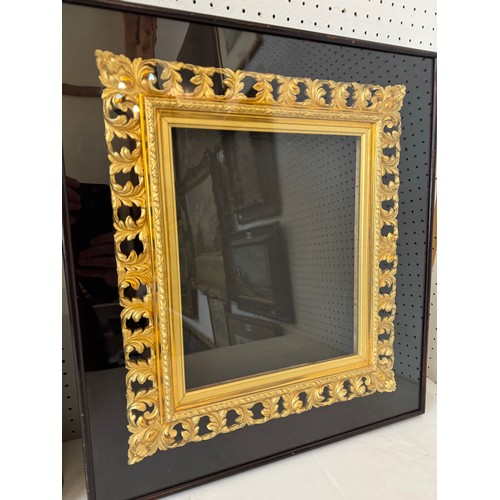 1655 - A pair of ornate pierced gilt frames with scrolling leaf decorations, housed in shadow box frames, B... 