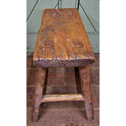 1476 - A rustic elm stool, the rectangular top raised on splayed supports, 50cm high