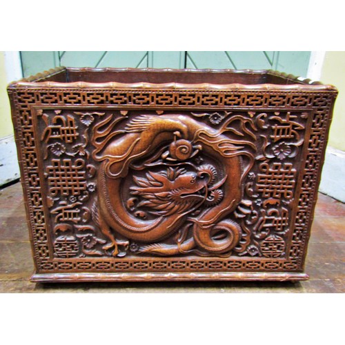 1376 - A Chinese carved rectangular hardwood box, with dragon, cloud and other detail, within a geometric b... 