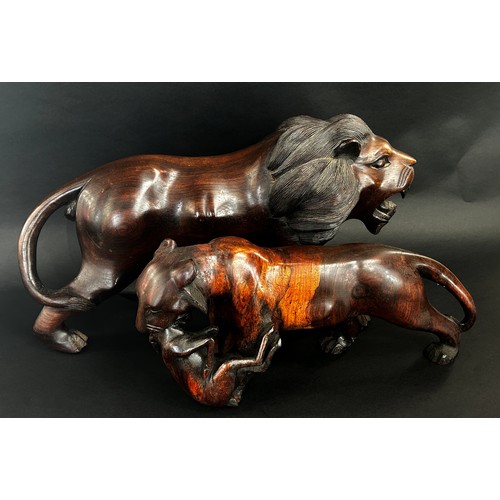 1743 - A large heavy carved Eastern hardwood study of a lion and associated lioness with kill (2)