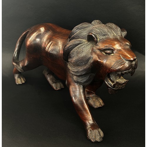 1743 - A large heavy carved Eastern hardwood study of a lion and associated lioness with kill (2)