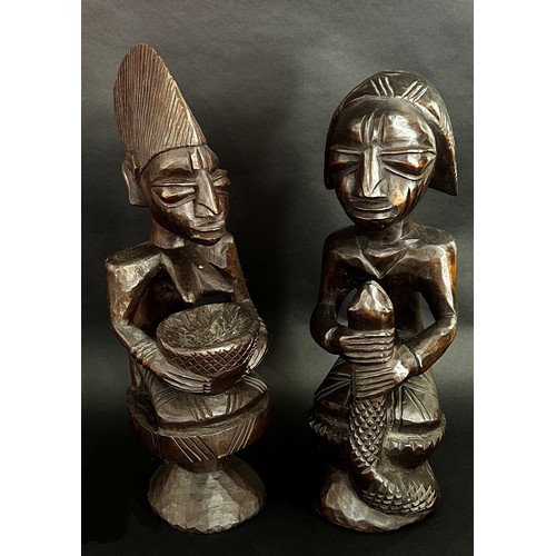 1737 - A pair of central African carved hardwood figures, possibly Yoruba, detailing a male, possibly an Ob... 