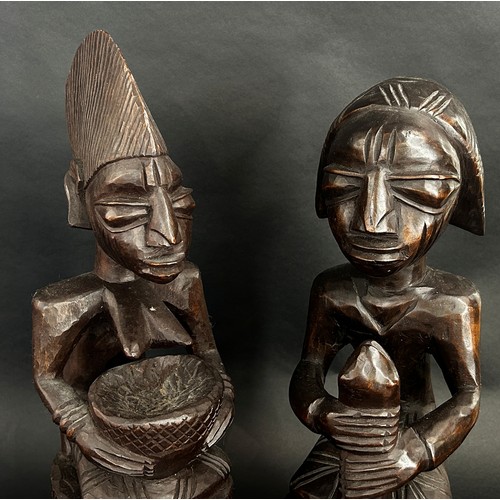 1737 - A pair of central African carved hardwood figures, possibly Yoruba, detailing a male, possibly an Ob... 