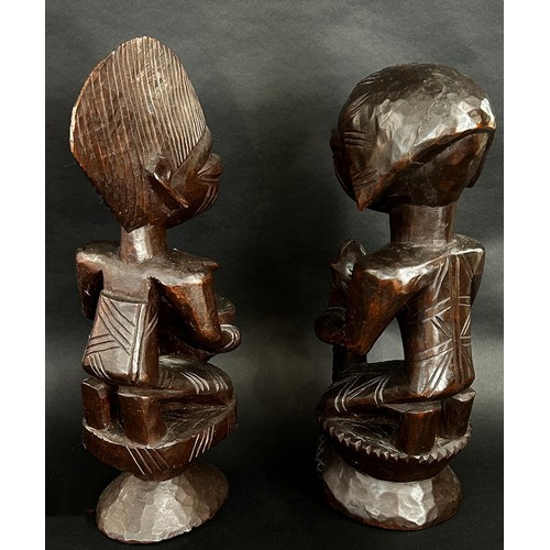 1737 - A pair of central African carved hardwood figures, possibly Yoruba, detailing a male, possibly an Ob... 