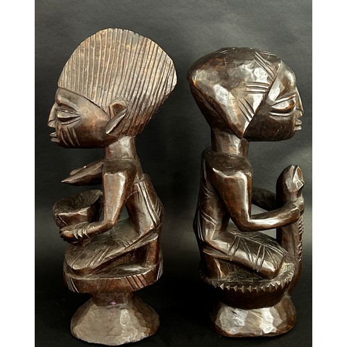 1737 - A pair of central African carved hardwood figures, possibly Yoruba, detailing a male, possibly an Ob... 