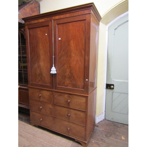 1357 - An early 19th century mahogany linen press of two long and two short drawers, enclosed by two matche... 